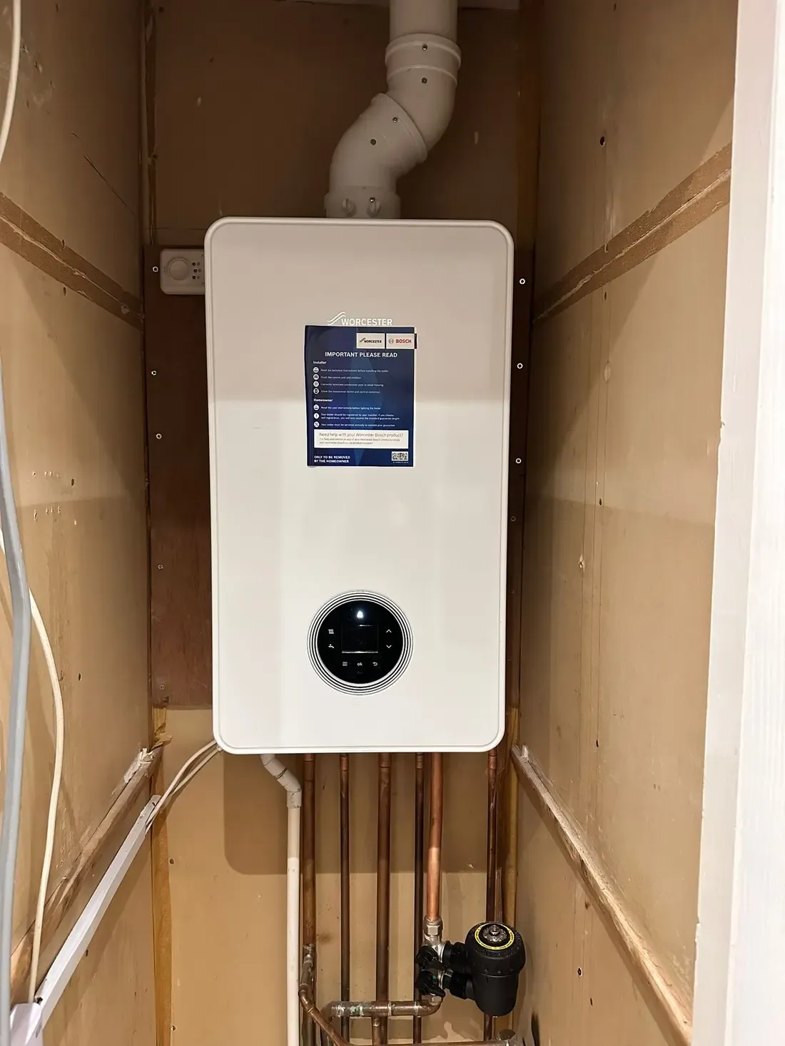 Newly commissioned Worcester Bosch combi boiler with its documentation attached